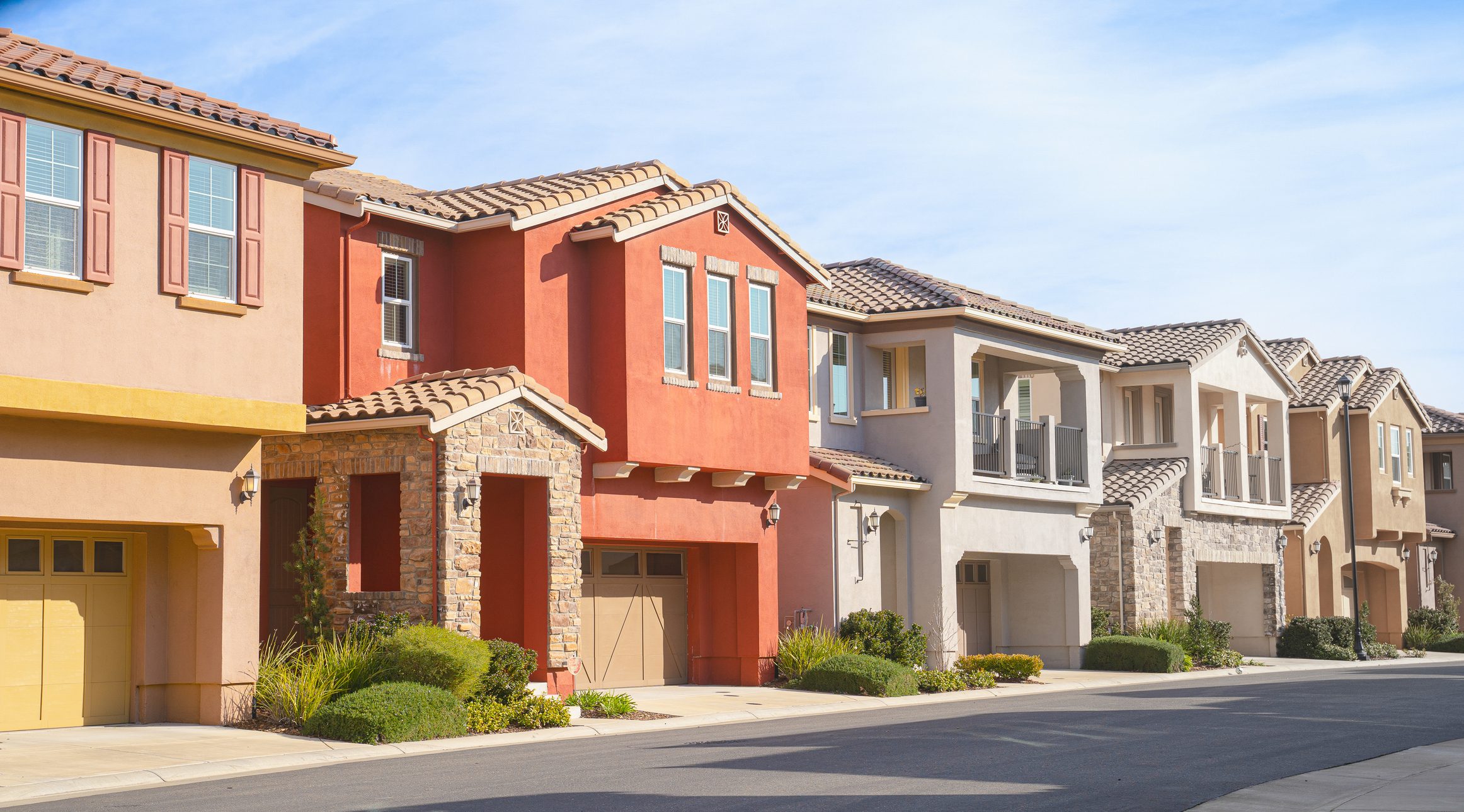Colorful suburban houses on a sunny street.